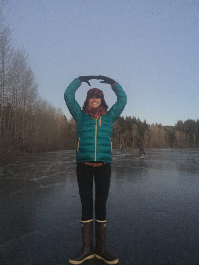 woman on a frozen lake near bellingham washington posing like a ballerina