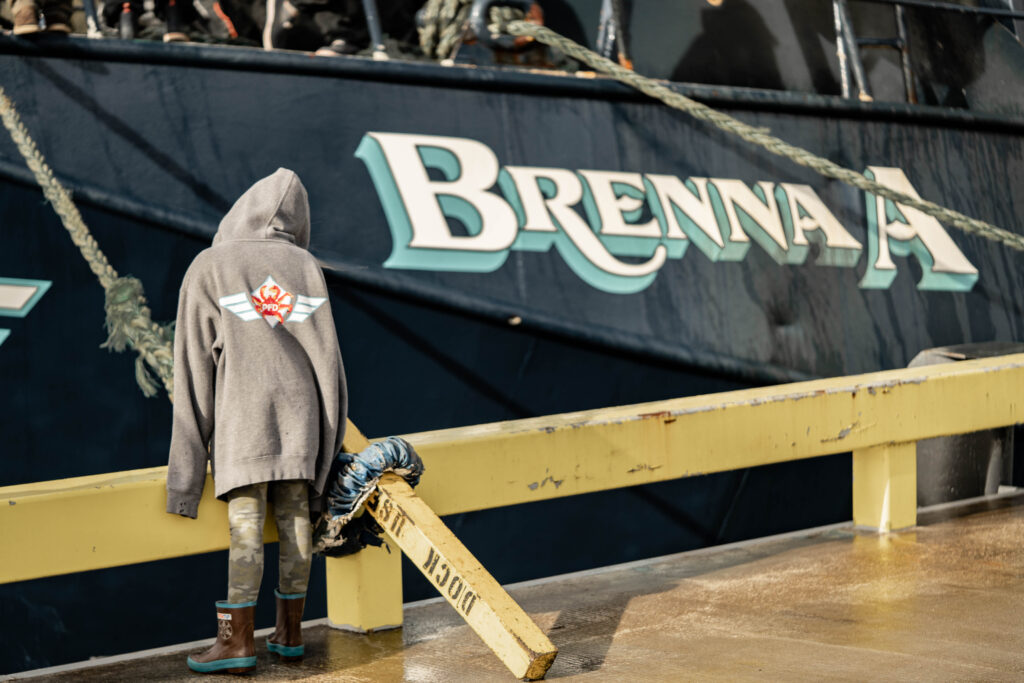 Child looking at commercial fishing crab boat