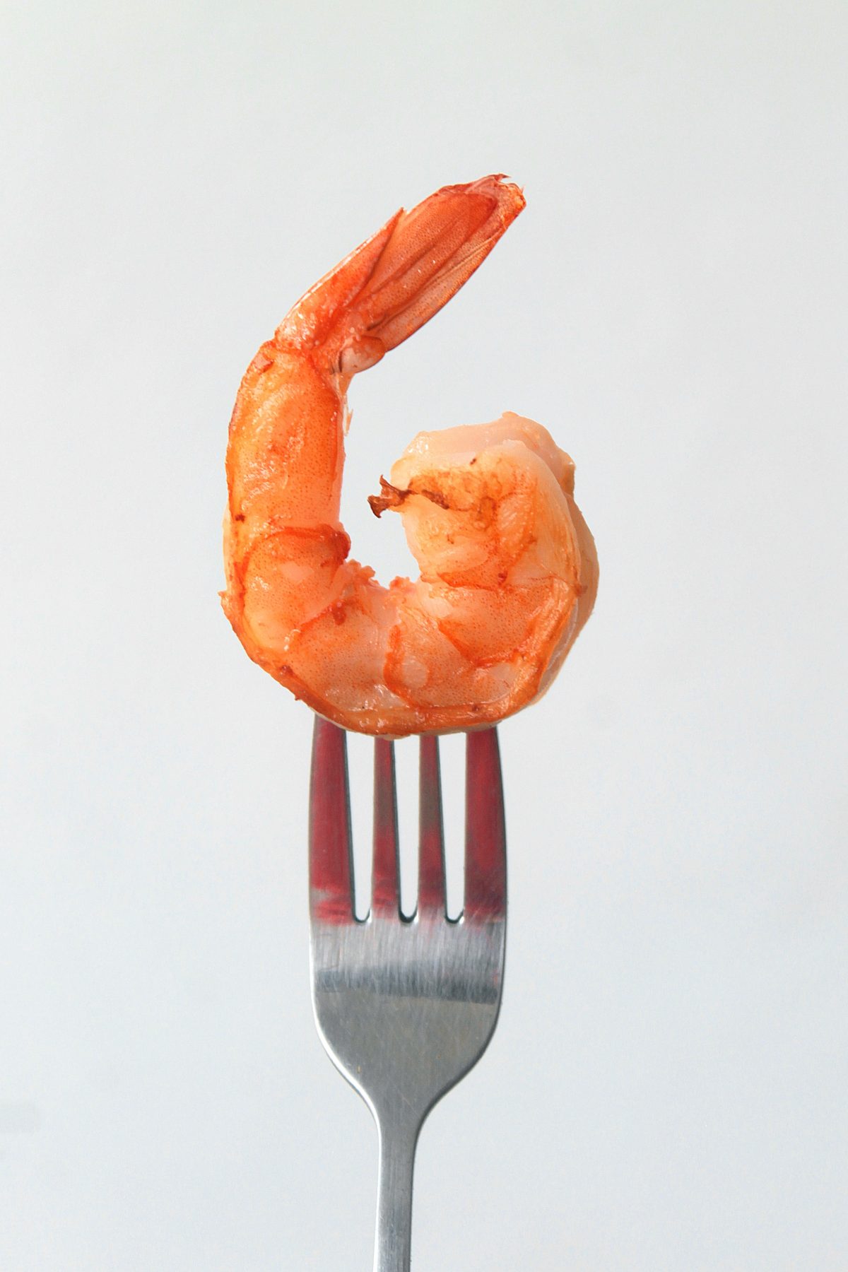 Cooked shrimp on silver fork