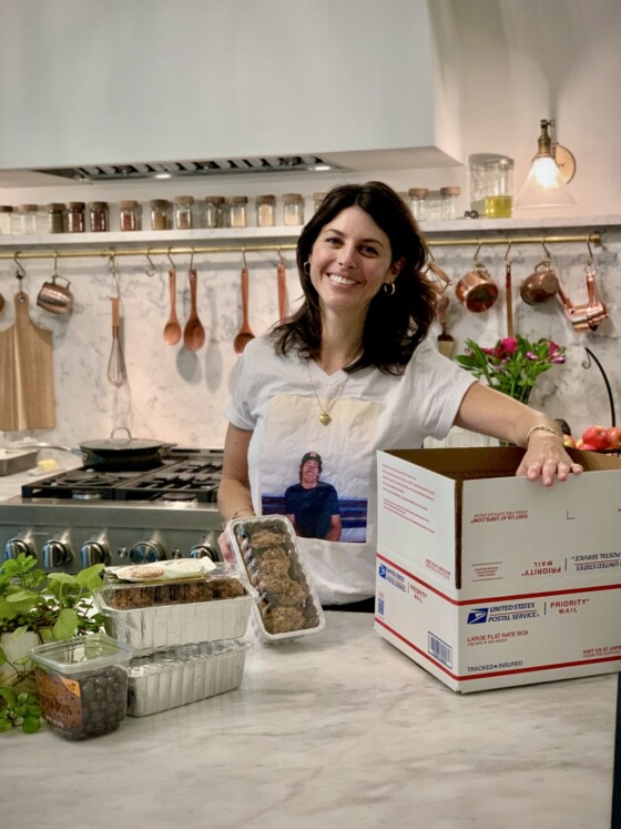 Megan Waldrep in Kitchen with a care package for a commercial fisherman